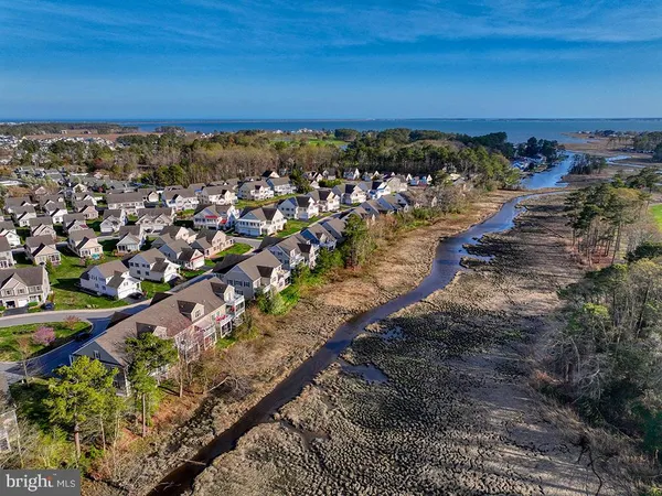 an aerial view of a houses with a yard