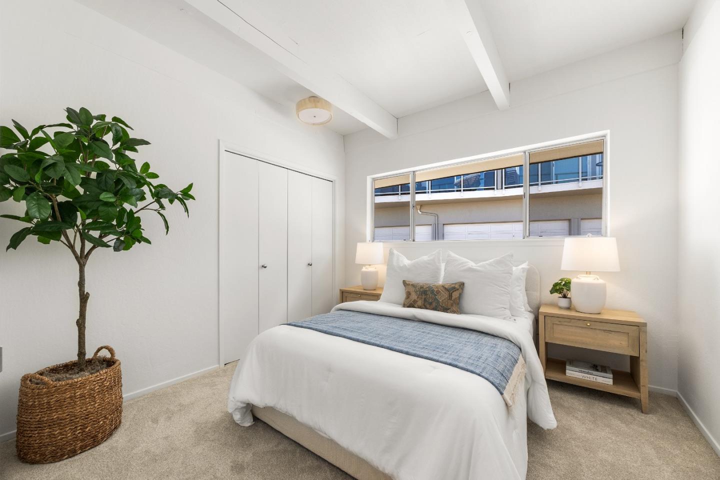 230 Rio Del Mar Boulevard, Unit K Aptos, CA 95003 - Photo 18 of 29 a bedroom with a bed and a potted plant