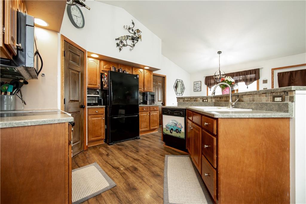 200 Shields Road Slippery Rock, PA 16057 - Photo 11 of 43 a kitchen with stainless steel appliances granite countertop a refrigerator a stove and a sink with wooden floor