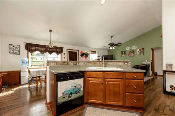 a kitchen with a stove and a wooden floor