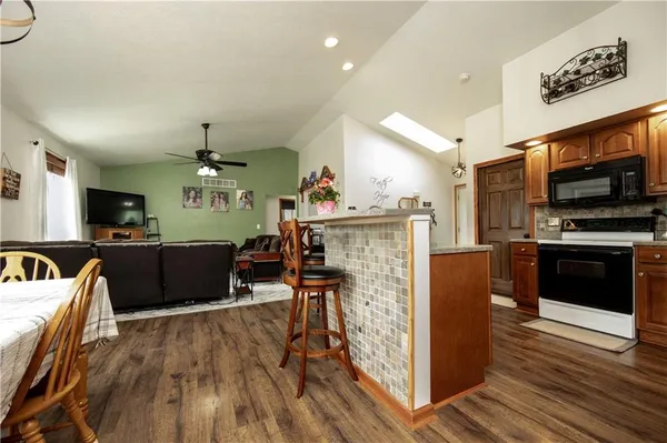 a view of kitchen with sink microwave and refrigerator