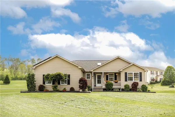 a front view of a house with a yard