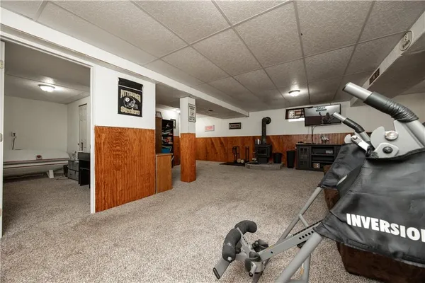 a bedroom with a bed and dresser with mirror