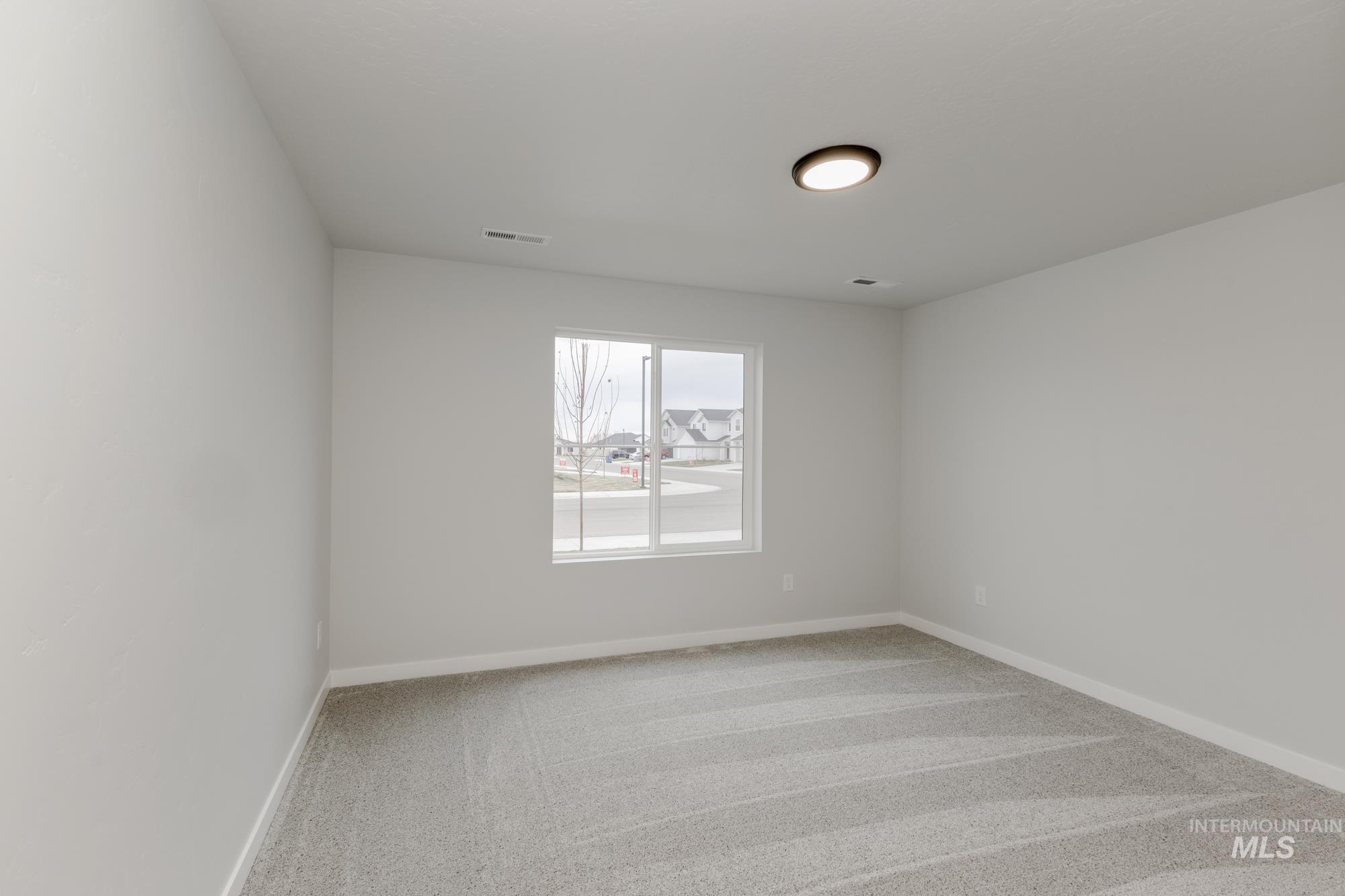 16329 Fill Avenue Caldwell, ID 83607 - Photo 12 of 18 Empty room with light colored carpet and baseboards