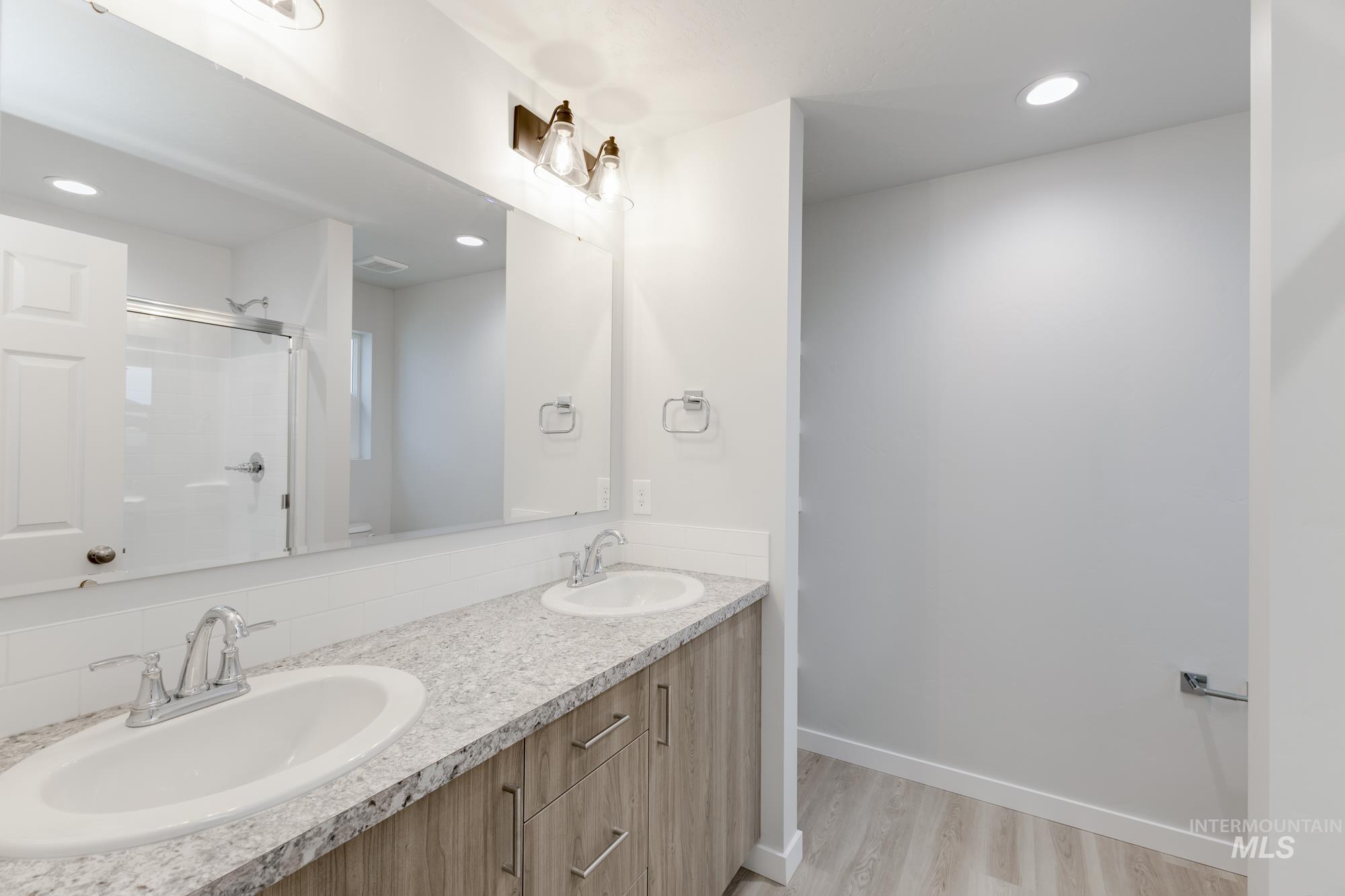 16329 Fill Avenue Caldwell, ID 83607 - Photo 17 of 18 Full bath featuring double vanity, a stall shower, recessed lighting, and light wood-style floors