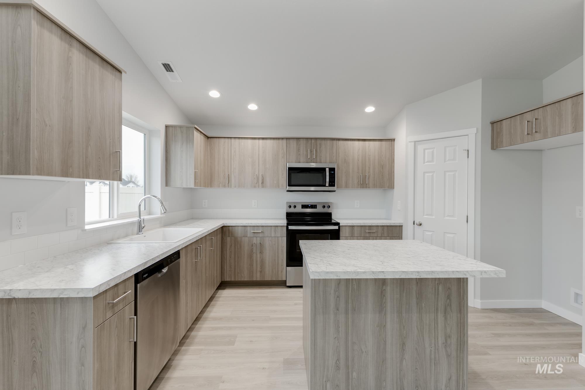 16329 Fill Avenue Caldwell, ID 83607 - Photo 4 of 18 Kitchen with appliances with stainless steel finishes, light countertops, a kitchen island, modern cabinets, and recessed lighting