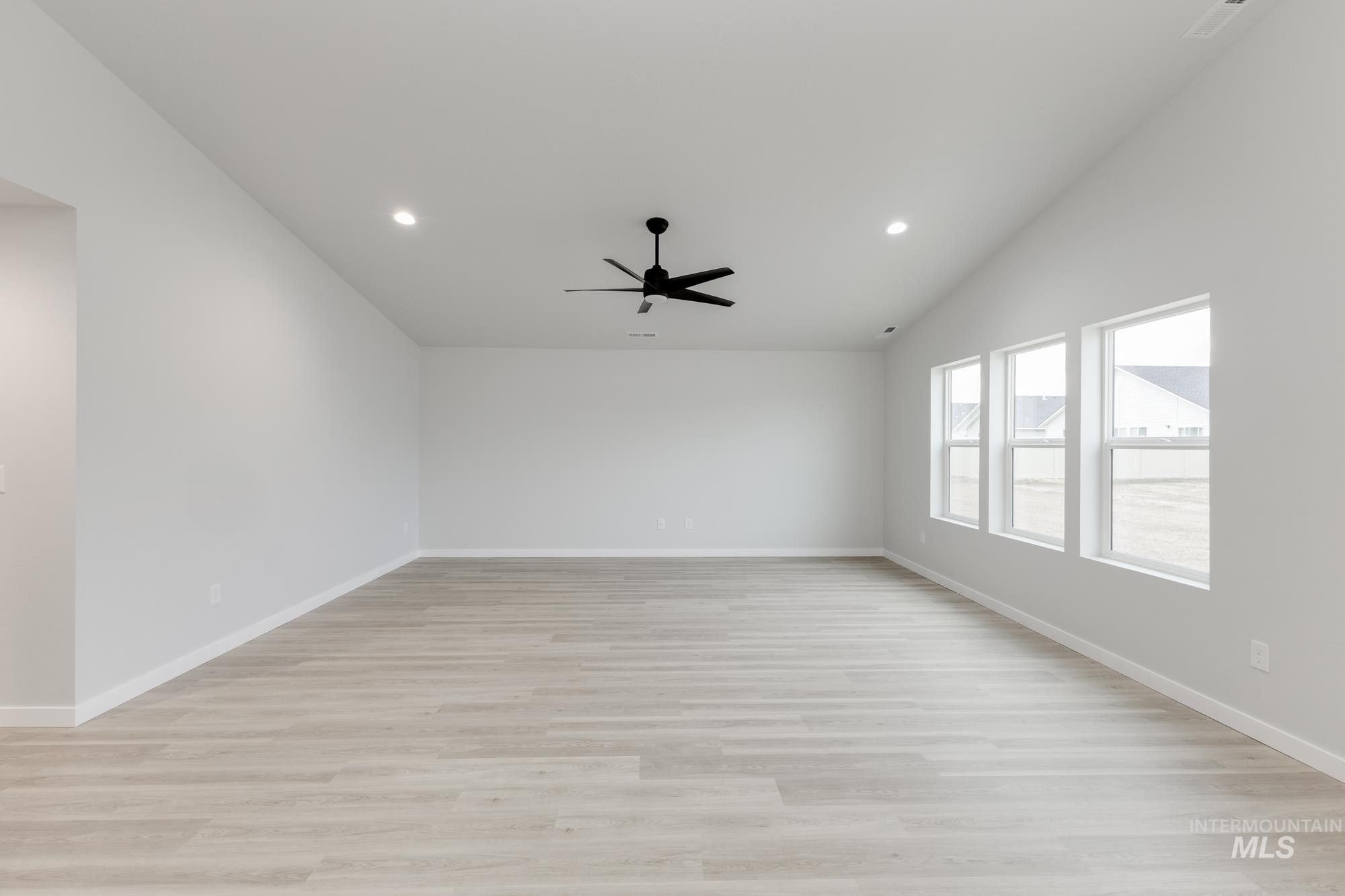 16329 Fill Avenue Caldwell, ID 83607 - Photo 7 of 18 Empty room featuring recessed lighting, lofted ceiling, light wood-type flooring, and ceiling fan
