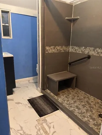 a kitchen with granite countertop a stove a sink and a microwave