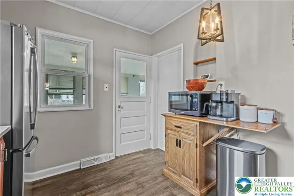 a kitchen with stainless steel appliances a stove and cabinets