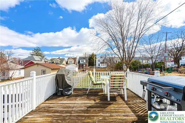 a view of a patio with iron fence