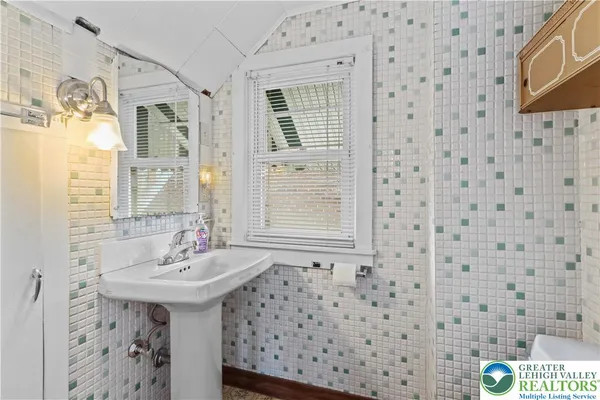 a bathroom with a sink a mirror and a shower