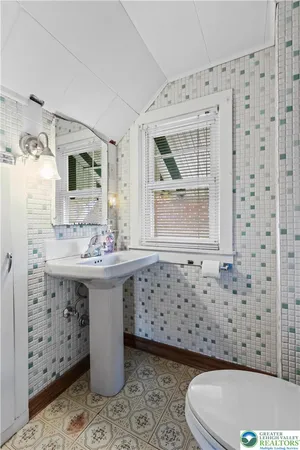 a bathroom with a sink toilet and mirror