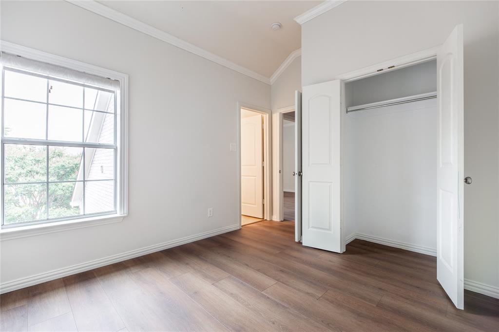 1020 Rodin Lane Carrollton, TX 75006 - Photo 18 of 25 an empty room with wooden floor and windows