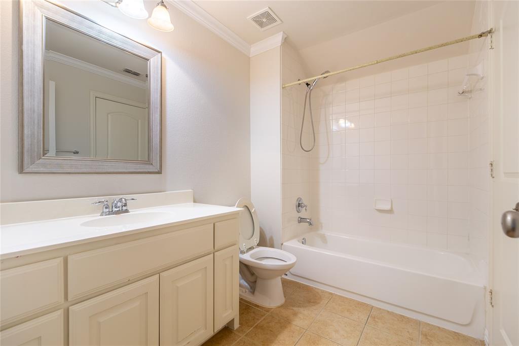 1020 Rodin Lane Carrollton, TX 75006 - Photo 19 of 25 a bathroom with a sink a toilet and a bathtub
