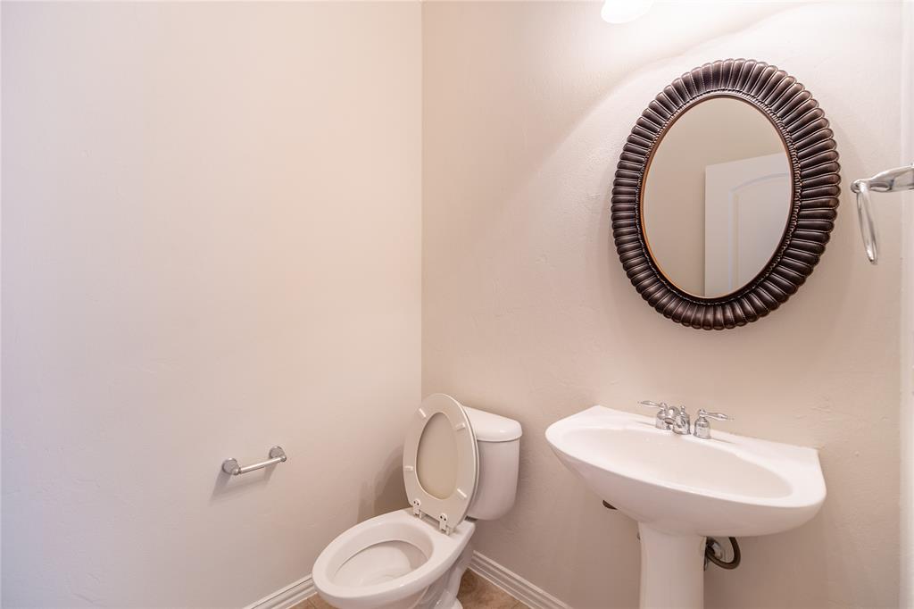 1020 Rodin Lane Carrollton, TX 75006 - Photo 21 of 25 a bathroom with a sink and a mirror