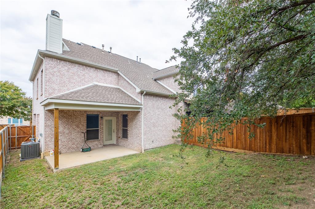 1020 Rodin Lane Carrollton, TX 75006 - Photo 23 of 25 a view of a house with backyard and a tree