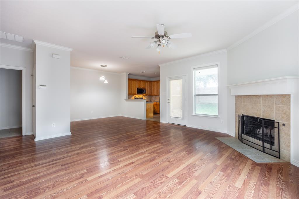 1020 Rodin Lane Carrollton, TX 75006 - Photo 4 of 25 a view of empty room with wooden floor and fireplace