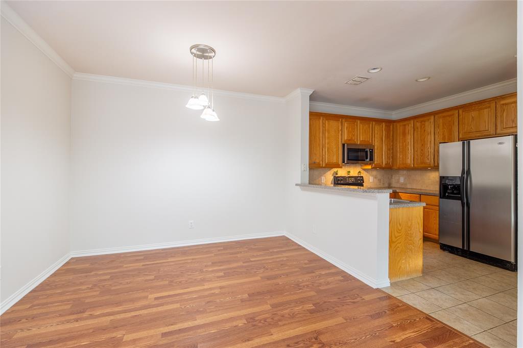 1020 Rodin Lane Carrollton, TX 75006 - Photo 6 of 25 a view of a kitchen with a sink and a refrigerator