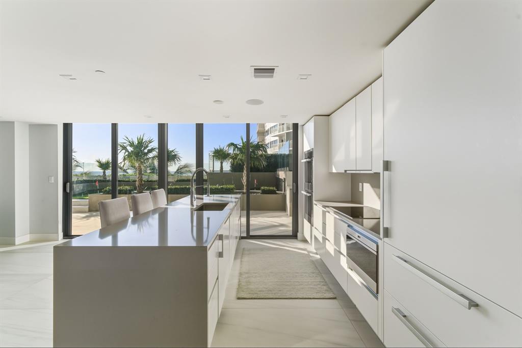 730 North Ocean Boulevard, Unit 404 Pompano Beach, FL 33062 - Photo 13 of 47 a view of a kitchen with kitchen island and stainless steel appliances