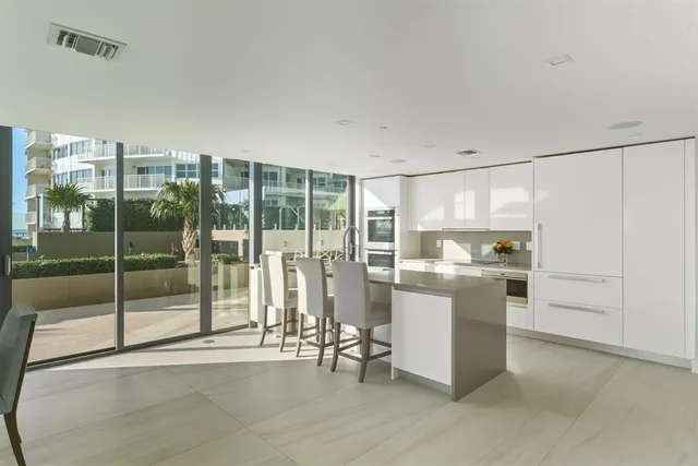 a bedroom with a bed couch and large window