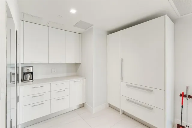 a bathroom with a tub a sink and mirror