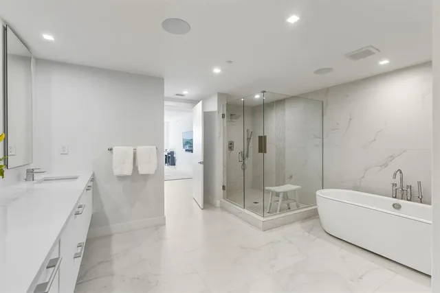 a bedroom with a large bed and a large window