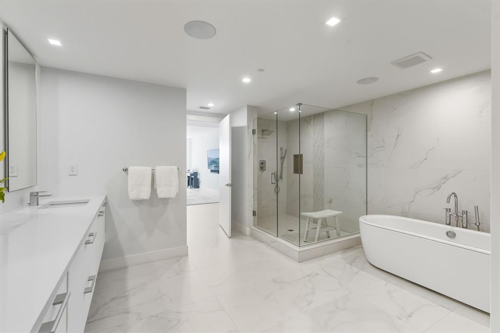 730 North Ocean Boulevard, Unit 404 Pompano Beach, FL 33062 - Photo 17 of 47 a bathroom with a tub a sink and mirror