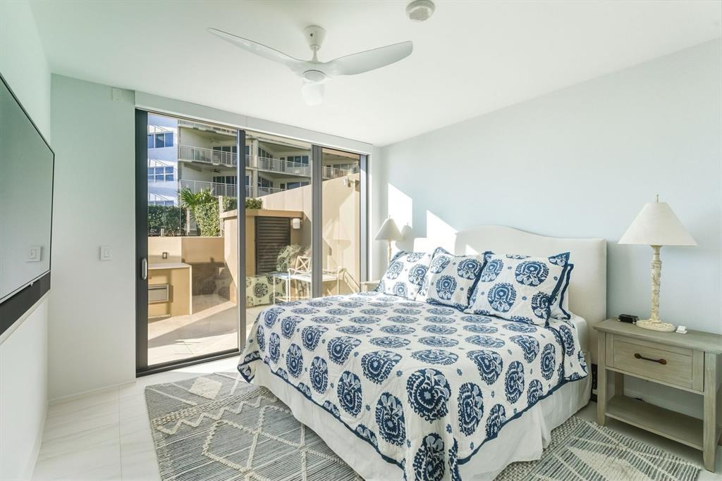 730 North Ocean Boulevard, Unit 404 Pompano Beach, FL 33062 - Photo 22 of 47 a bedroom with a large bed and a window