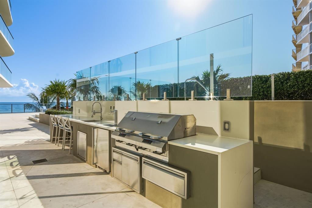 730 North Ocean Boulevard, Unit 404 Pompano Beach, FL 33062 - Photo 31 of 47 a view of a patio with a table and chairs