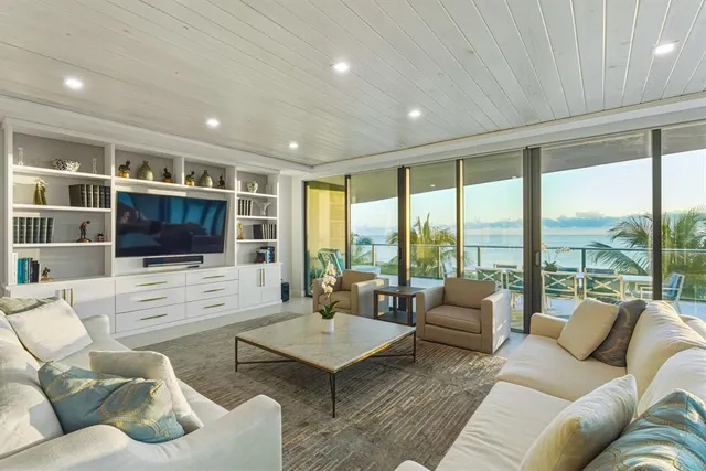 a living room with furniture floor and a flat screen tv