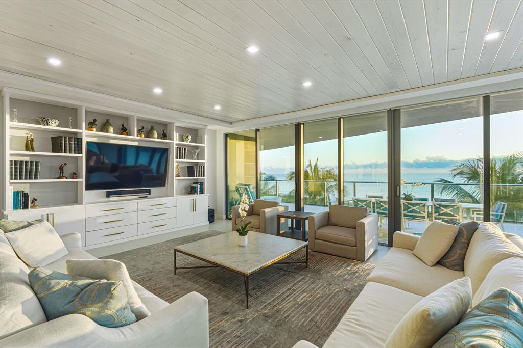 730 North Ocean Boulevard, Unit 404 Pompano Beach, FL 33062 - Photo 4 of 47 a living room with furniture floor and a flat screen tv