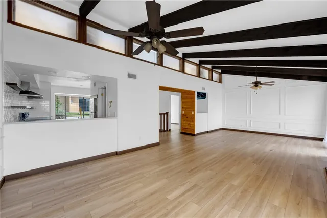 a view of a room with wooden floors and cabinet