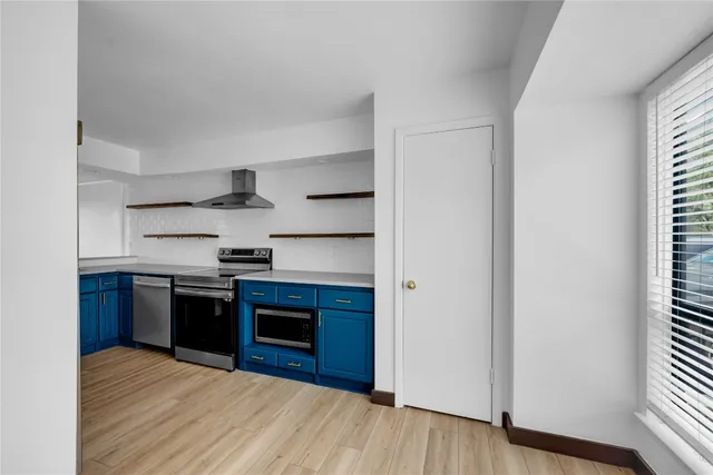 a kitchen with stainless steel appliances granite countertop a stove and a refrigerator
