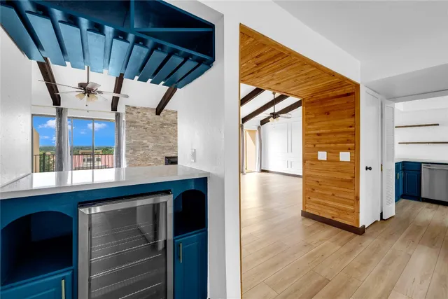 a view of a hallway with wooden floors and stairs