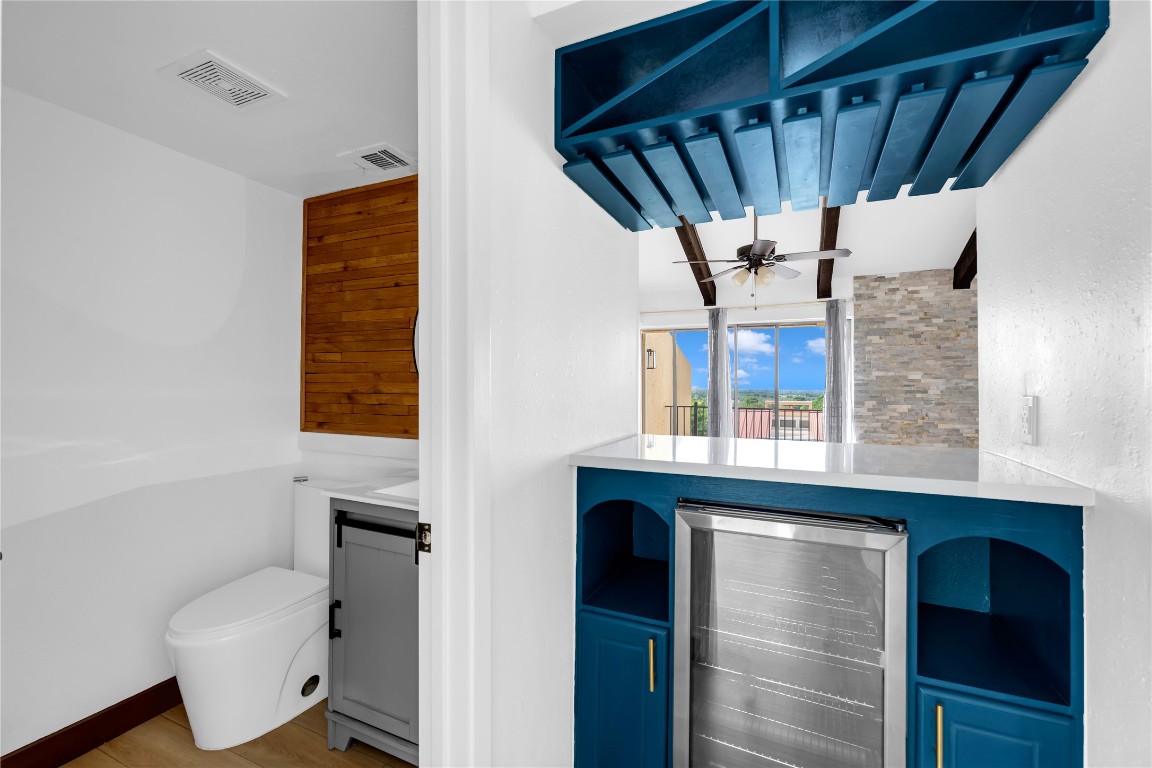 402 Hi Stirrup, Unit E2 Horseshoe Bay, TX 78657 - Photo 19 of 39 a view of a hallway with a chair and potted plant next to a window