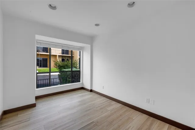 a view of hallway with wooden floor and doors