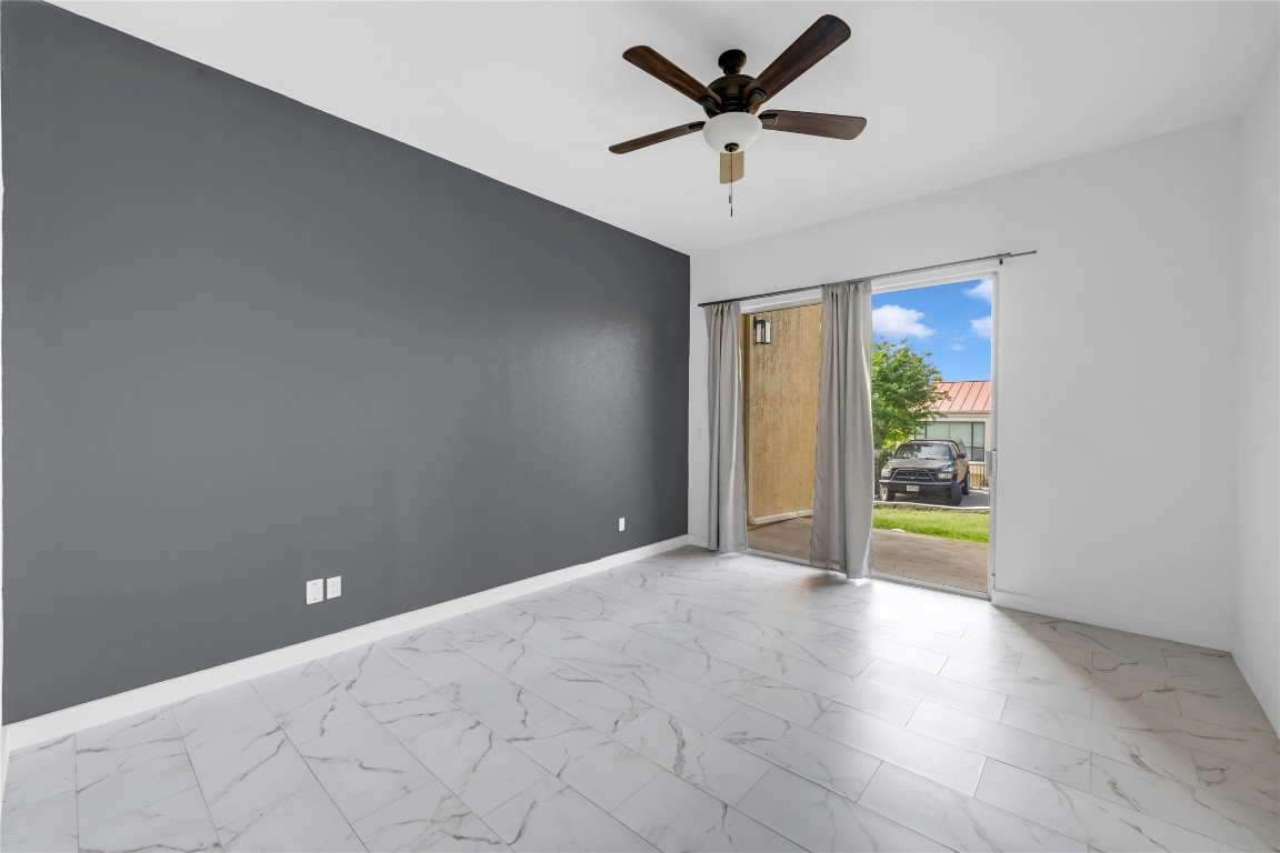 402 Hi Stirrup, Unit E2 Horseshoe Bay, TX 78657 - Photo 25 of 39 an empty room with fan and windows
