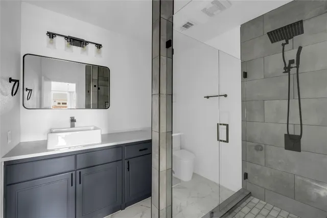 a bathroom with a toilet sink and shower