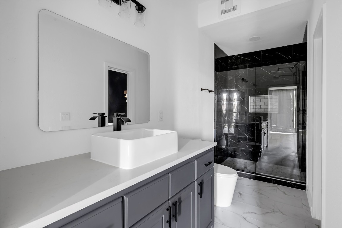 402 Hi Stirrup, Unit E2 Horseshoe Bay, TX 78657 - Photo 32 of 39 a bathroom with a sink a toilet and shower