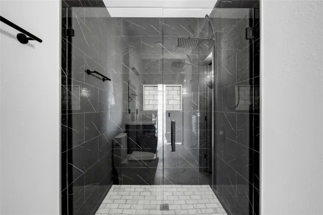 a bathroom with a glass shower door