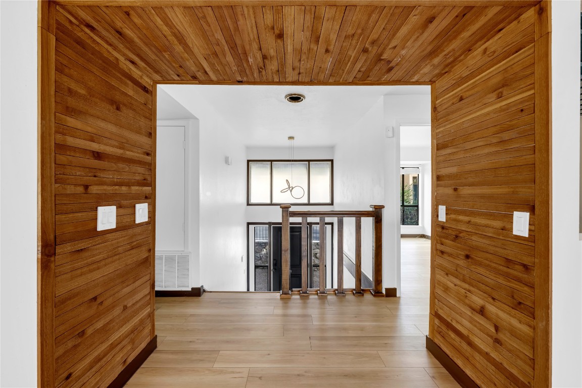 402 Hi Stirrup, Unit E2 Horseshoe Bay, TX 78657 - Photo 6 of 39 a view of a hallway with wooden floor and staircase