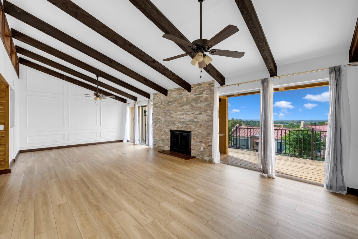 402 Hi Stirrup, Unit E2 Horseshoe Bay, TX 78657 - Photo 8 of 39 a view of a livingroom with wooden floor a ceiling fan and window