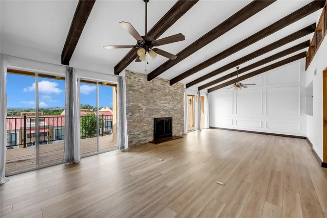 wooden floor in an empty room with a fireplace