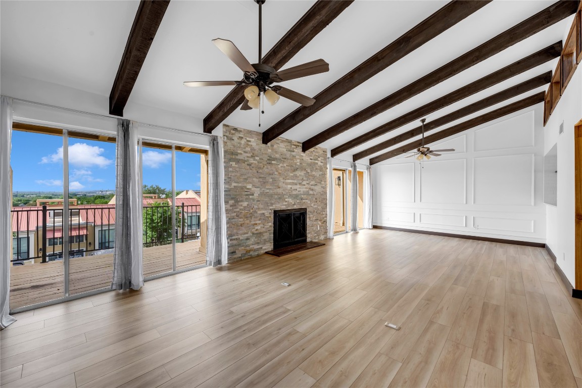 402 Hi Stirrup, Unit E2 Horseshoe Bay, TX 78657 - Photo 10 of 39 wooden floor in an empty room with a fireplace