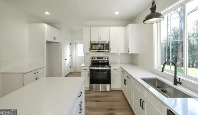 a kitchen with a sink stove and refrigerator