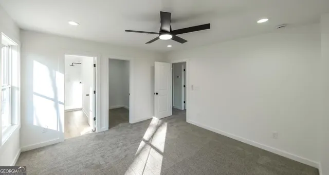 a view of a livingroom with a ceiling fan and window