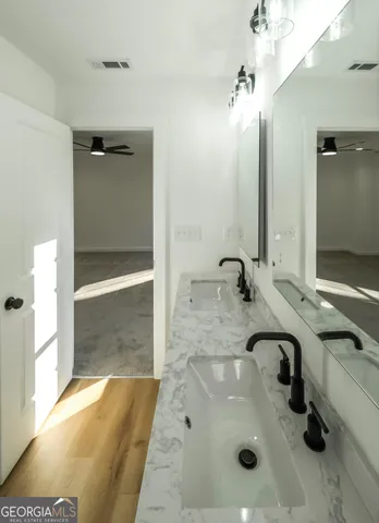 a bathroom with a sink and mirror