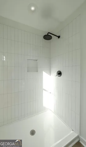 a bathroom with a shower and a tub
