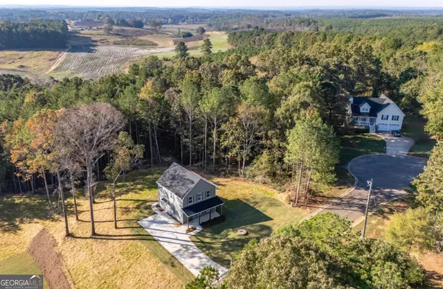 an aerial view of a house with a yard and lake view