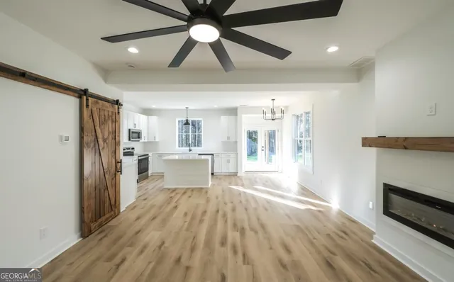 a view of a kitchen with a sink and a refrigerator